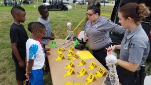 Crime Scene workers share their trade with children.